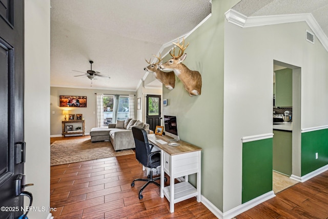 office space featuring crown molding, wood finished floors, visible vents, and a textured ceiling