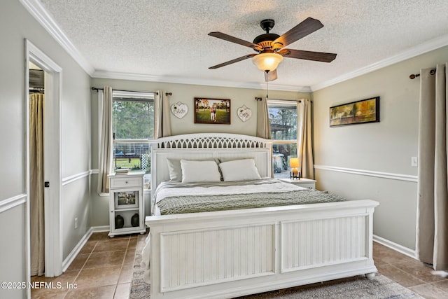 tiled bedroom featuring multiple windows, a textured ceiling, ceiling fan, and ornamental molding