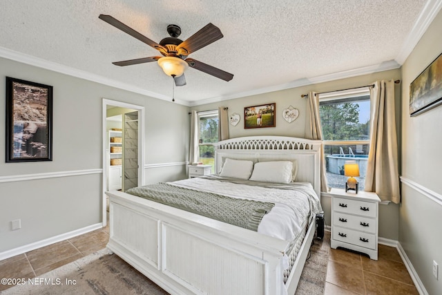 bedroom with tile patterned floors, multiple windows, a textured ceiling, and ornamental molding