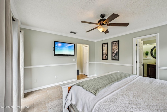 bedroom with a ceiling fan, baseboards, tile patterned flooring, a textured ceiling, and crown molding