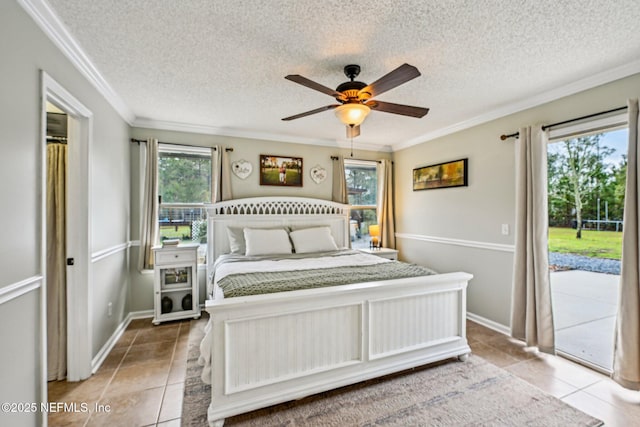 tiled bedroom featuring ceiling fan, crown molding, access to outside, and a textured ceiling