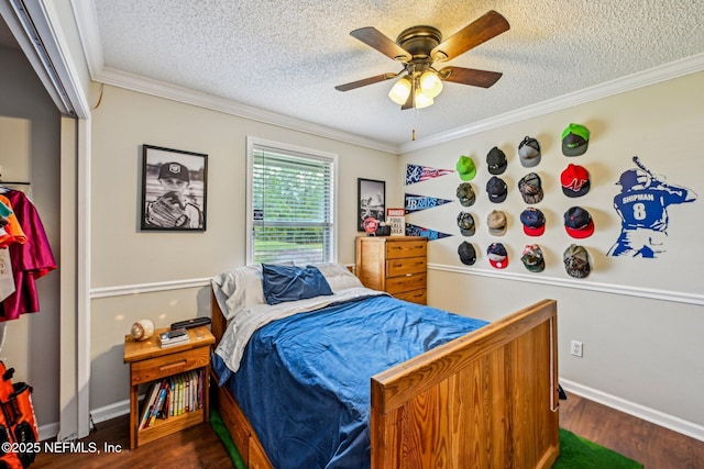 bedroom with ornamental molding, a textured ceiling, dark wood-style floors, baseboards, and ceiling fan