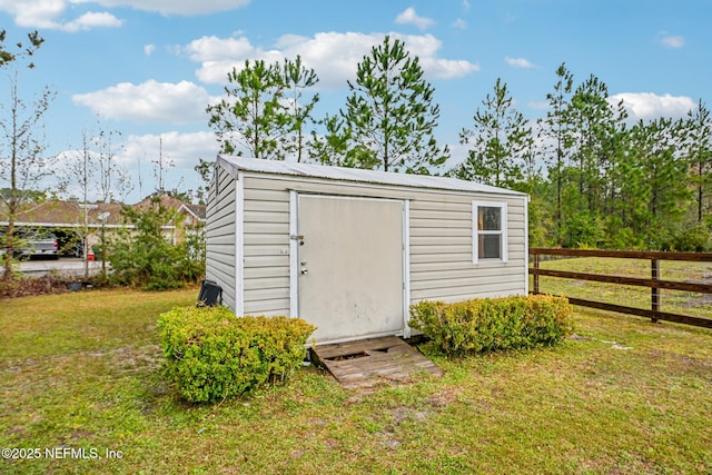 view of shed featuring fence