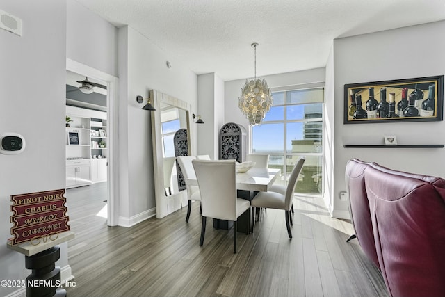 dining space featuring dark wood-style floors, plenty of natural light, visible vents, and a textured ceiling