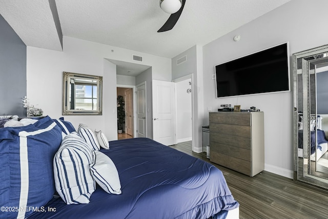 bedroom with visible vents, baseboards, ceiling fan, dark wood-type flooring, and a textured ceiling