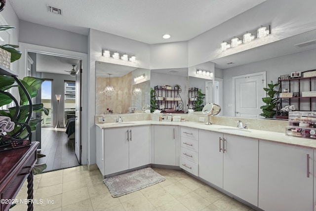 ensuite bathroom with double vanity, visible vents, a sink, and ensuite bathroom