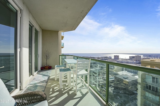 balcony featuring a city view and a water view