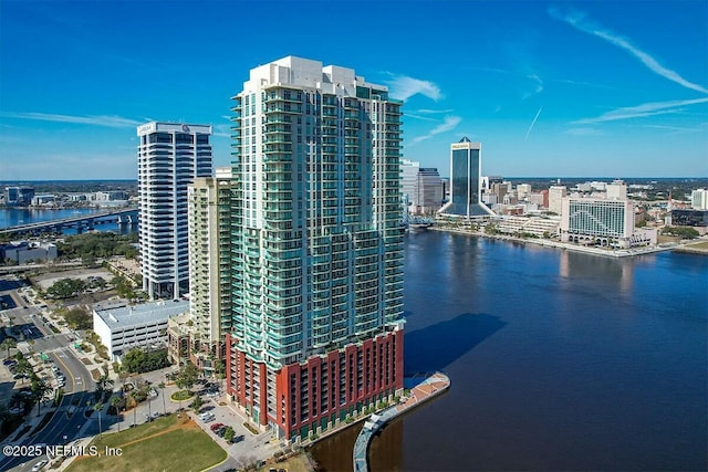 birds eye view of property with a view of city and a water view