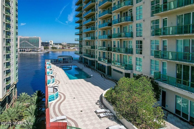 view of swimming pool featuring a water view
