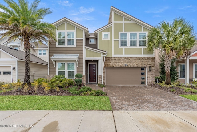 view of front of home with a garage, decorative driveway, and brick siding