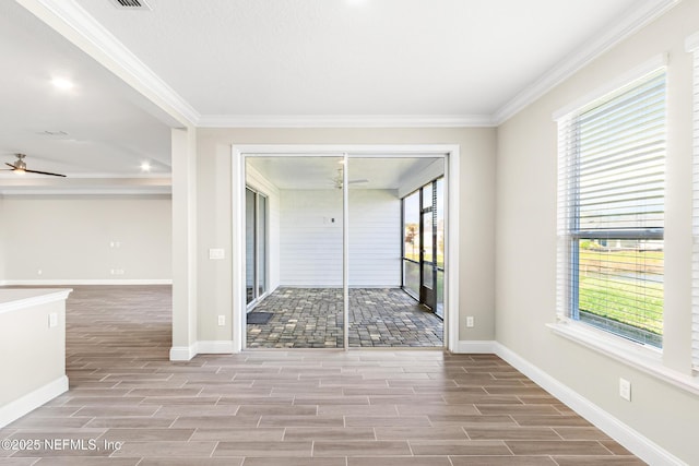 unfurnished room with crown molding, wood tiled floor, ceiling fan, and baseboards