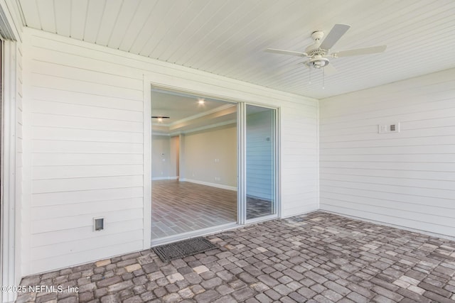 unfurnished sunroom featuring a ceiling fan and wood ceiling