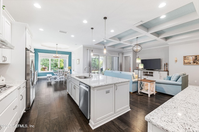 kitchen featuring open floor plan, white cabinetry, and an island with sink