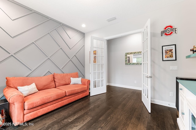 living room with baseboards, visible vents, dark wood finished floors, and french doors