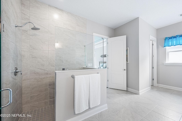 bathroom featuring a shower stall, visible vents, and baseboards