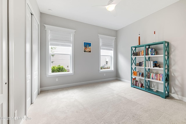 bedroom with baseboards, multiple windows, a closet, and light colored carpet