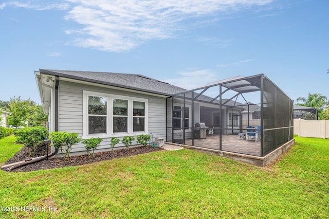 rear view of house with a yard, fence, and a patio