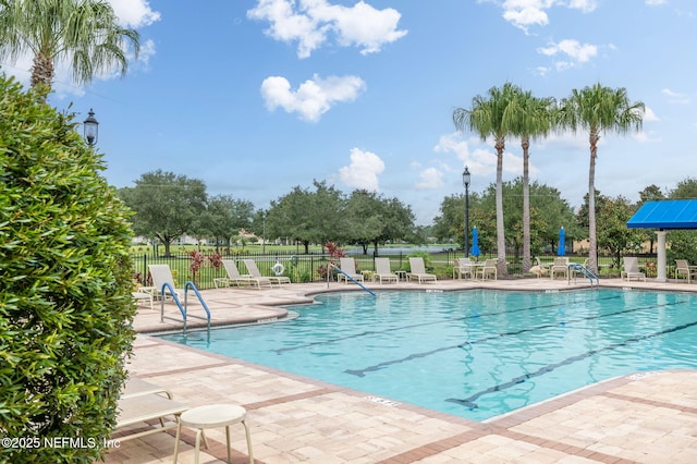 pool featuring a patio area and fence