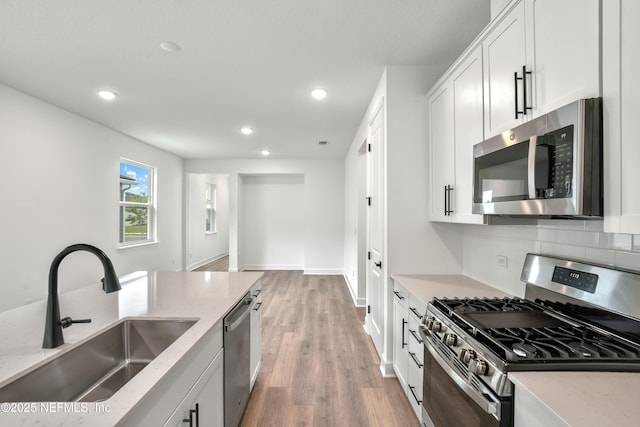 950 Lightsey Crossing Ln, Saint Augustine, FL 32084 - kitchen featuring recessed lighting, light stone countertops, appliances with stainless steel finishes, and a sink