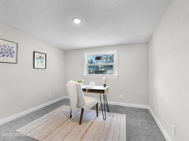 office space with a textured ceiling, carpet floors, and baseboards