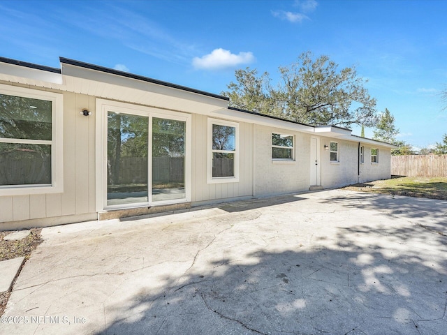 rear view of property with a patio area and fence