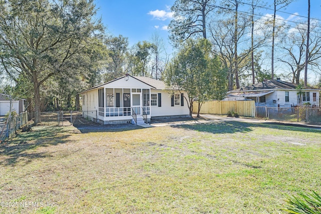 view of front of house with a sunroom, a fenced backyard, roof with shingles, crawl space, and a front yard