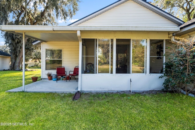 rear view of property featuring a yard and a patio area