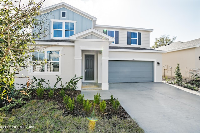 traditional-style home with board and batten siding, concrete driveway, and an attached garage