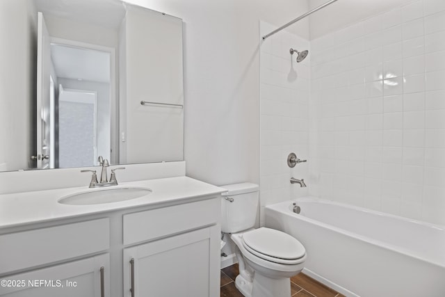 bathroom featuring bathtub / shower combination, vanity, toilet, and wood finished floors