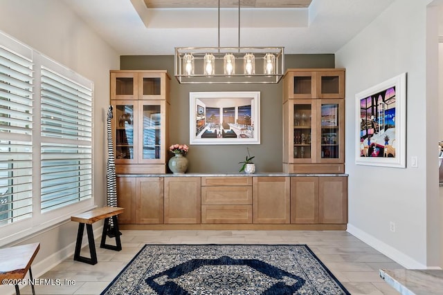 34072 Lavender Parke Dr, Fernandina Beach, FL 32034 - bar with baseboards, a tray ceiling, and pendant lighting