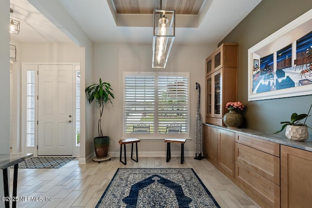 34072 Lavender Parke Dr, Fernandina Beach, FL 32034 - entrance foyer with a tray ceiling, wood finish floors, and baseboards