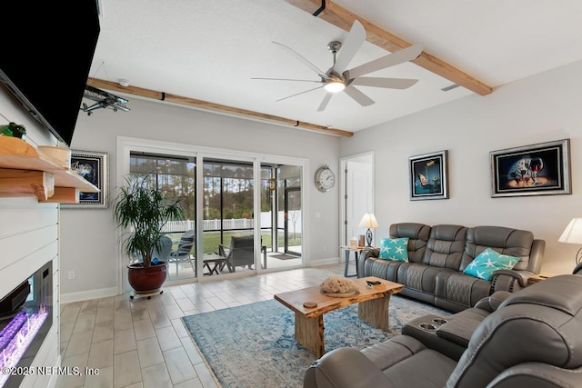 34072 Lavender Parke Dr, Fernandina Beach, FL 32034 - living room featuring a glass covered fireplace, beamed ceiling, baseboards, and ceiling fan