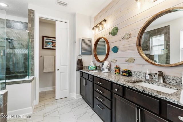 34072 Lavender Parke Dr, Fernandina Beach, FL 32034 - full bathroom with marble finish floor, visible vents, a tile shower, and a sink