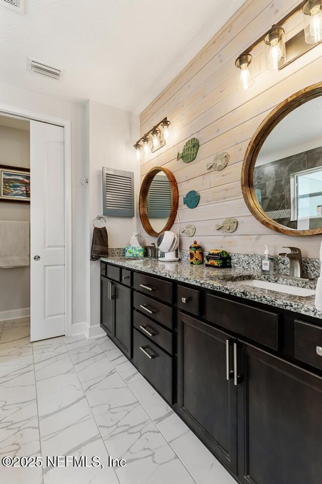 34072 Lavender Parke Dr, Fernandina Beach, FL 32034 - bathroom featuring a sink, visible vents, baseboards, marble finish floor, and double vanity