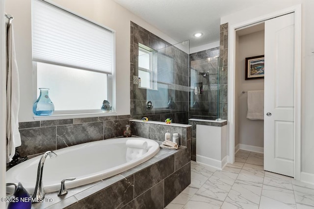 34072 Lavender Parke Dr, Fernandina Beach, FL 32034 - bathroom featuring marble finish floor, baseboards, a walk in shower, and a bath