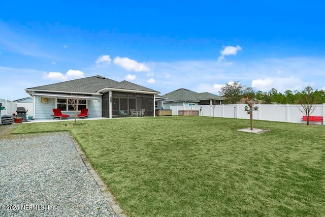 34072 Lavender Parke Dr, Fernandina Beach, FL 32034 - back of house featuring a sunroom, a fenced backyard, a patio area, and a lawn