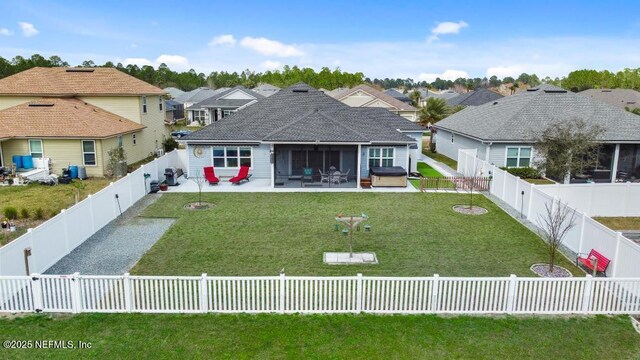 34072 Lavender Parke Dr, Fernandina Beach, FL 32034 - rear view of property with a fenced backyard, an outdoor hot tub, a yard, a residential view, and a patio area
