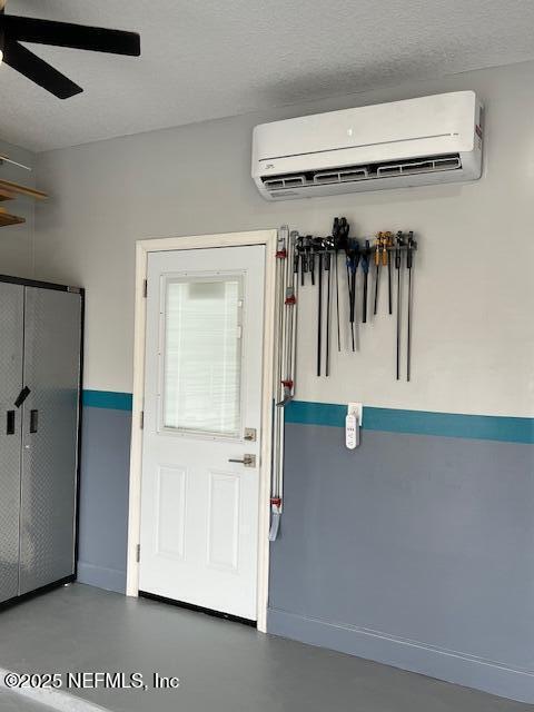 34072 Lavender Parke Dr, Fernandina Beach, FL 32034 - interior space featuring a wall mounted air conditioner, ceiling fan, finished concrete flooring, and a textured ceiling