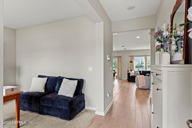 living area with light wood finished floors and baseboards