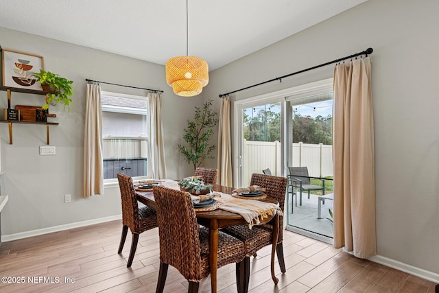 dining room with light wood-style flooring and baseboards