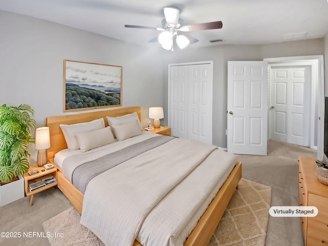 bedroom featuring light carpet, ceiling fan, visible vents, and a closet