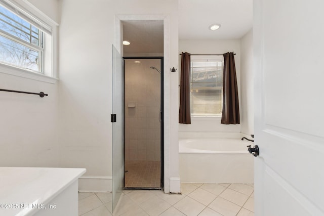 full bath featuring a stall shower, tile patterned flooring, and a garden tub