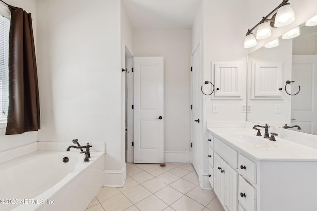 bathroom with tile patterned flooring, vanity, baseboards, and a bath