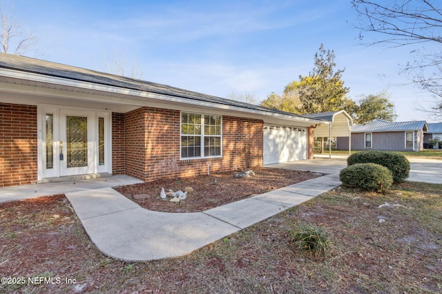 view of front of home with an attached garage and brick siding