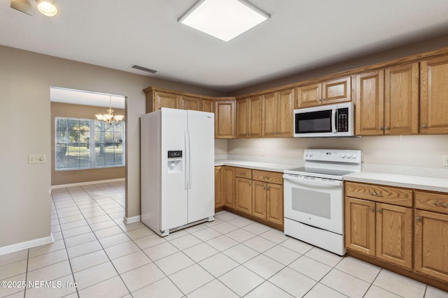 kitchen featuring white appliances, visible vents, light countertops, and brown cabinetry