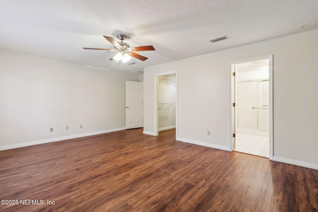 unfurnished bedroom with dark wood-style flooring and baseboards