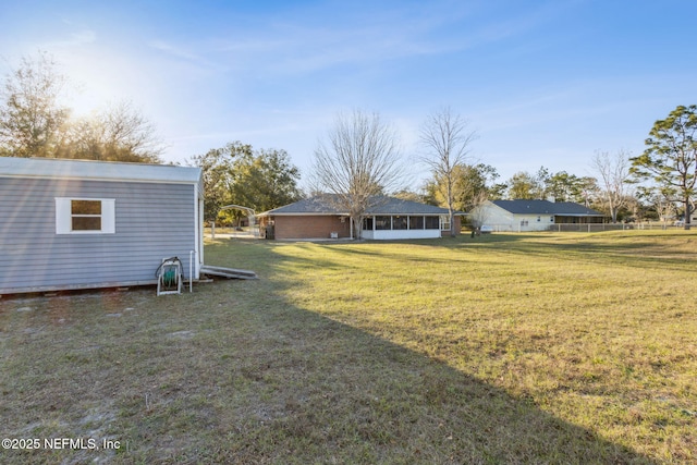 view of yard with a sunroom