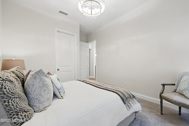 bedroom with a notable chandelier, visible vents, baseboards, a closet, and carpet