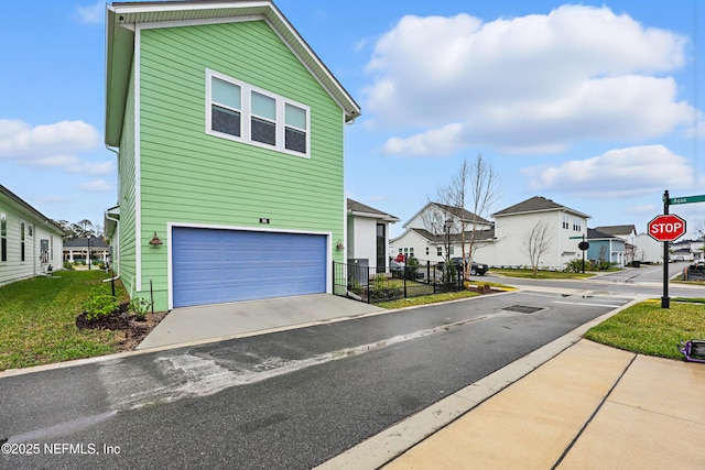 view of front of property featuring a residential view and fence