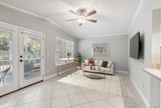 living room with light tile patterned floors, a ceiling fan, lofted ceiling, and ornamental molding